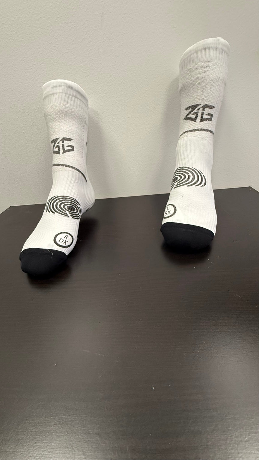 Actual Zero Give cotton-free soccer grip socks showing anatomical right and left construction